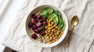 Quinoa bowl topped with roasted beetroot, chickpeas and spinach