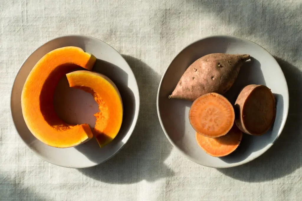 Butternut squash and sweet potato side by side, photographed for nutritional comparison
