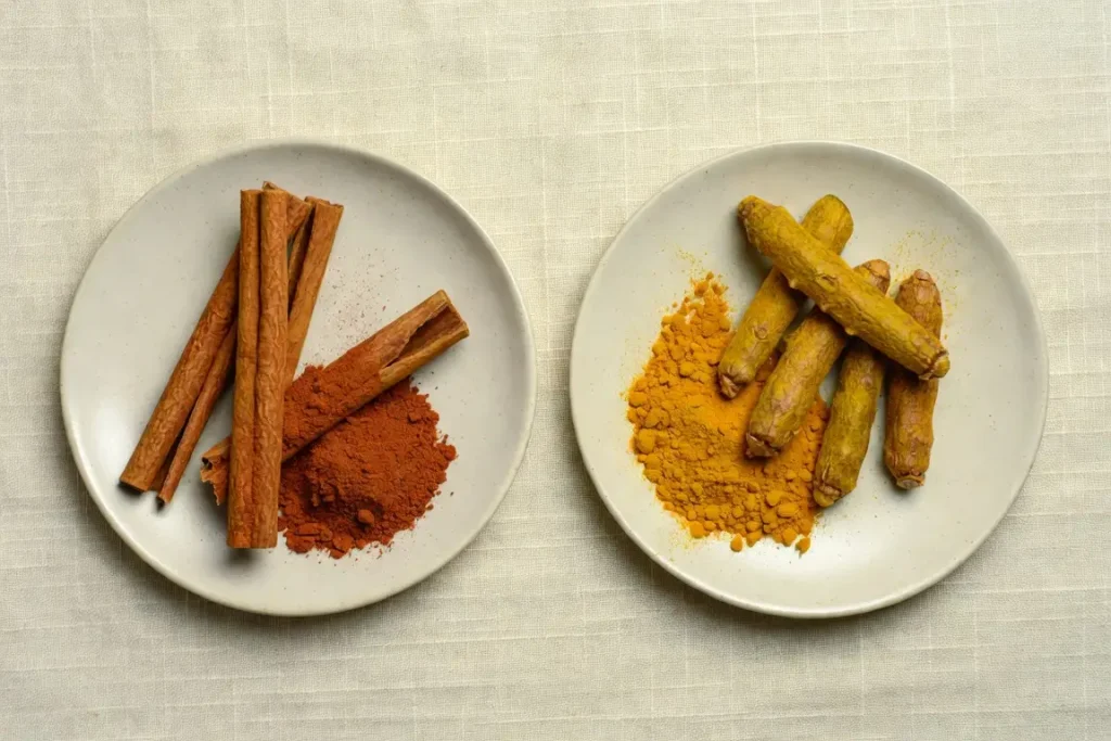 Cinnamon and turmeric side by side, photographed for nutritional comparison