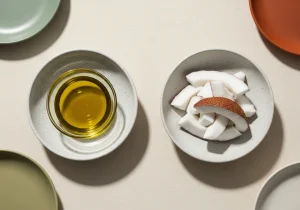 Extra virgin olive oil and coconut side by side, photographed for nutritional comparison