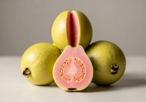 Guava cut open to show the pink flesh
