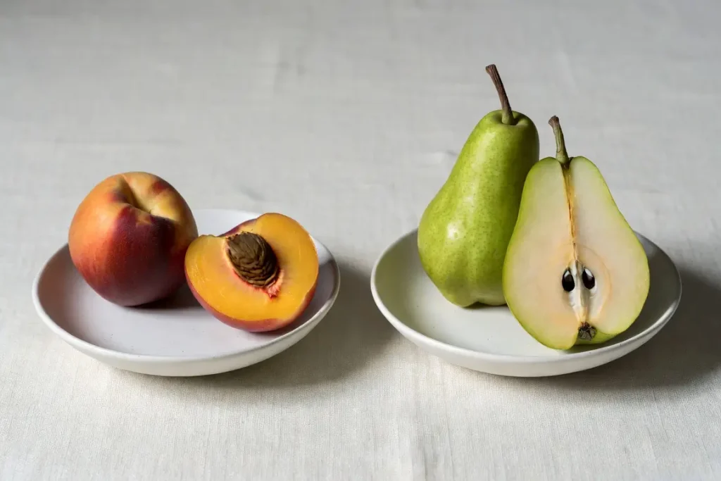 Peach and pear side by side, photographed for nutritional comparison