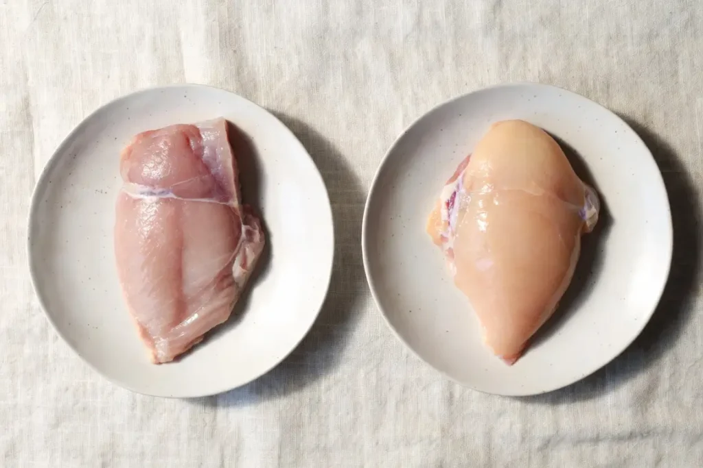 Turkey breast and chicken breast side by side, photographed for nutritional comparison